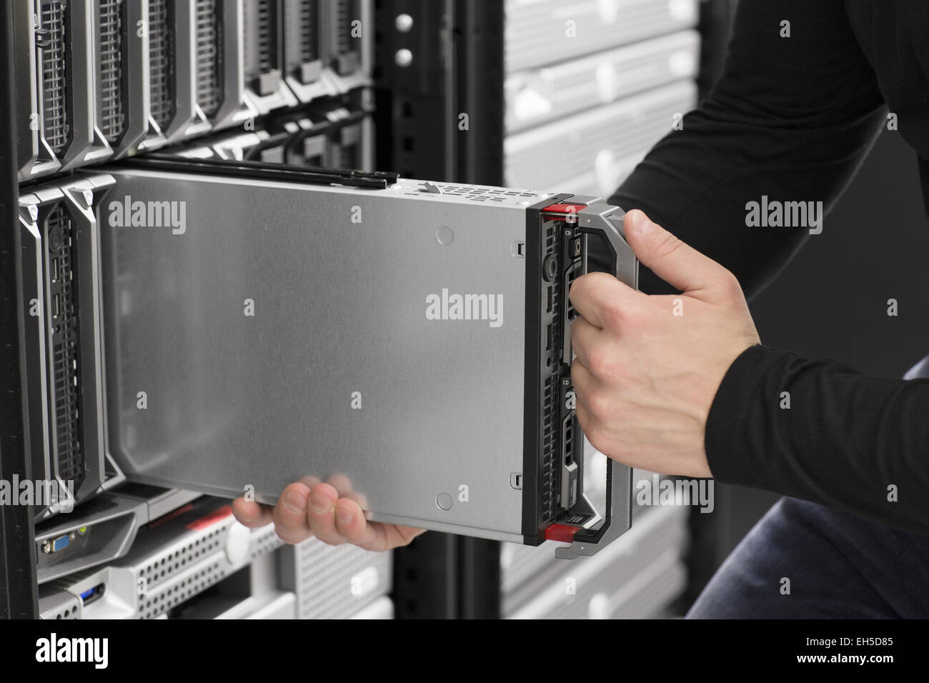 IT technician / engineer install / removes / replace a blade server in a data center. Stock Photo