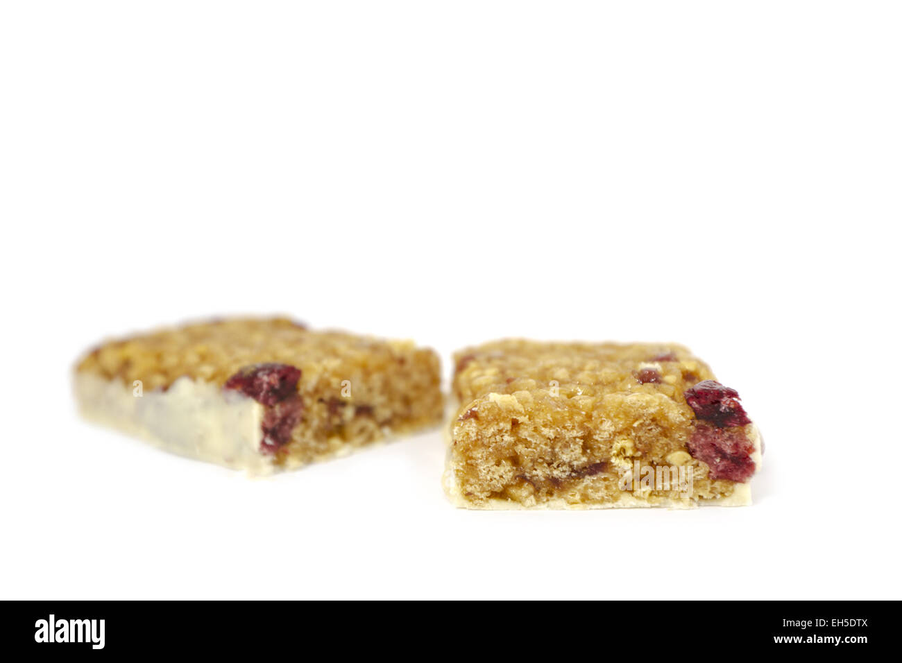 Raw Low carbohydrate bar with cranberries on white background. Stock Photo