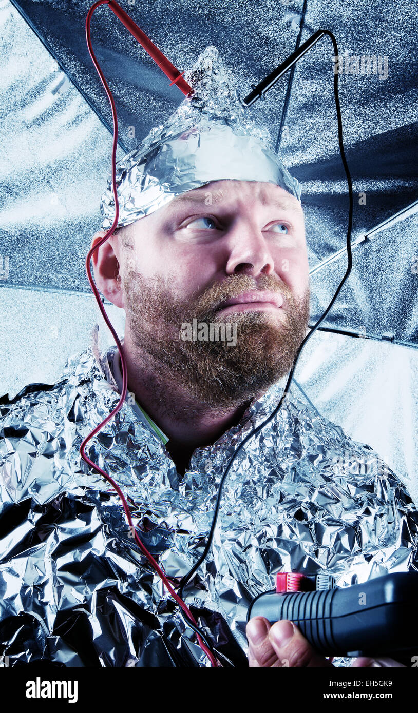 A paranoid guy scared for extraterrestrials / aliens / chemtrails. Stock Photo