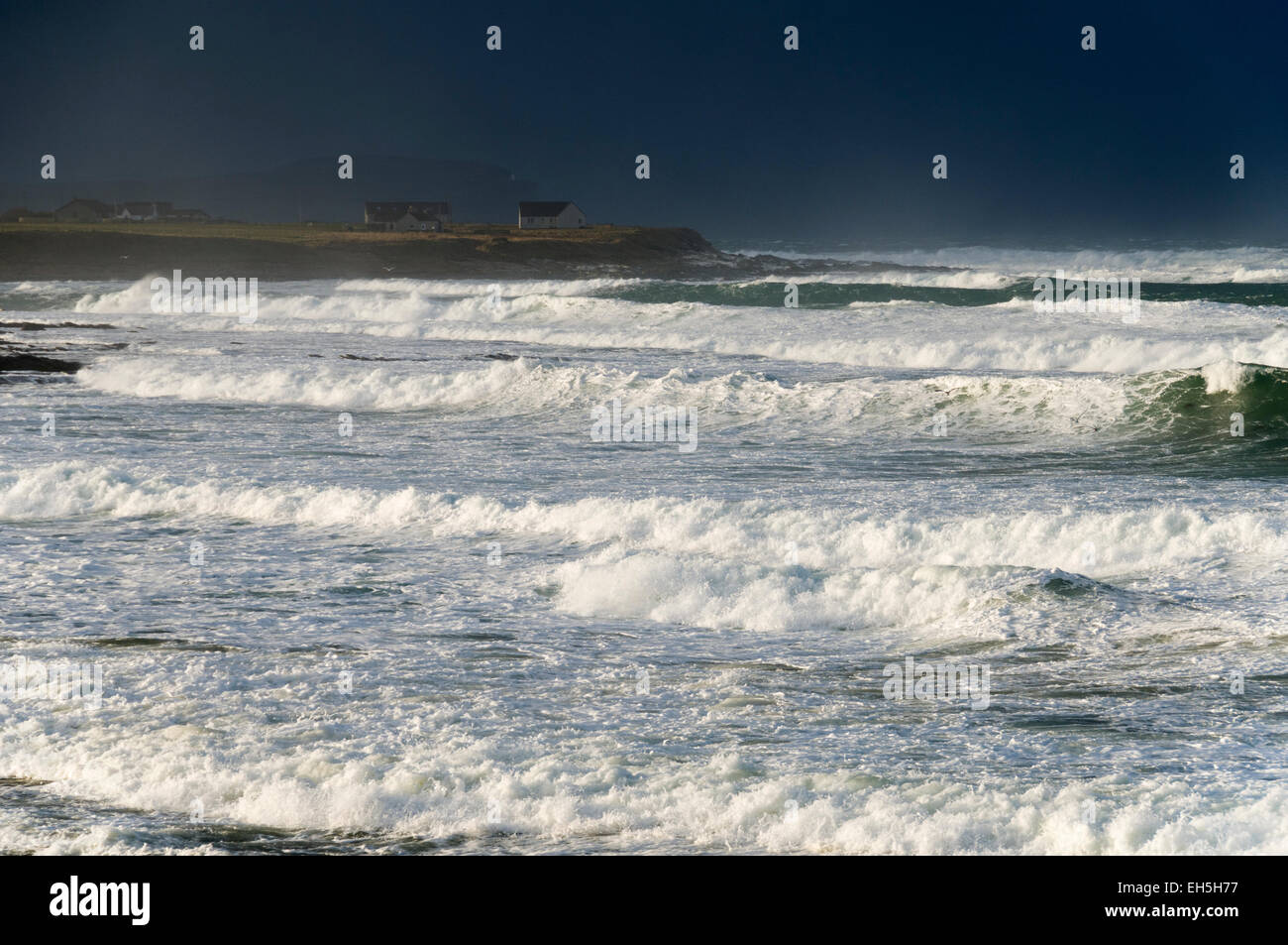 Large waves on a beach near the village of Mey, Caithness, Scotland, UK, on a very stormy day. Stock Photo