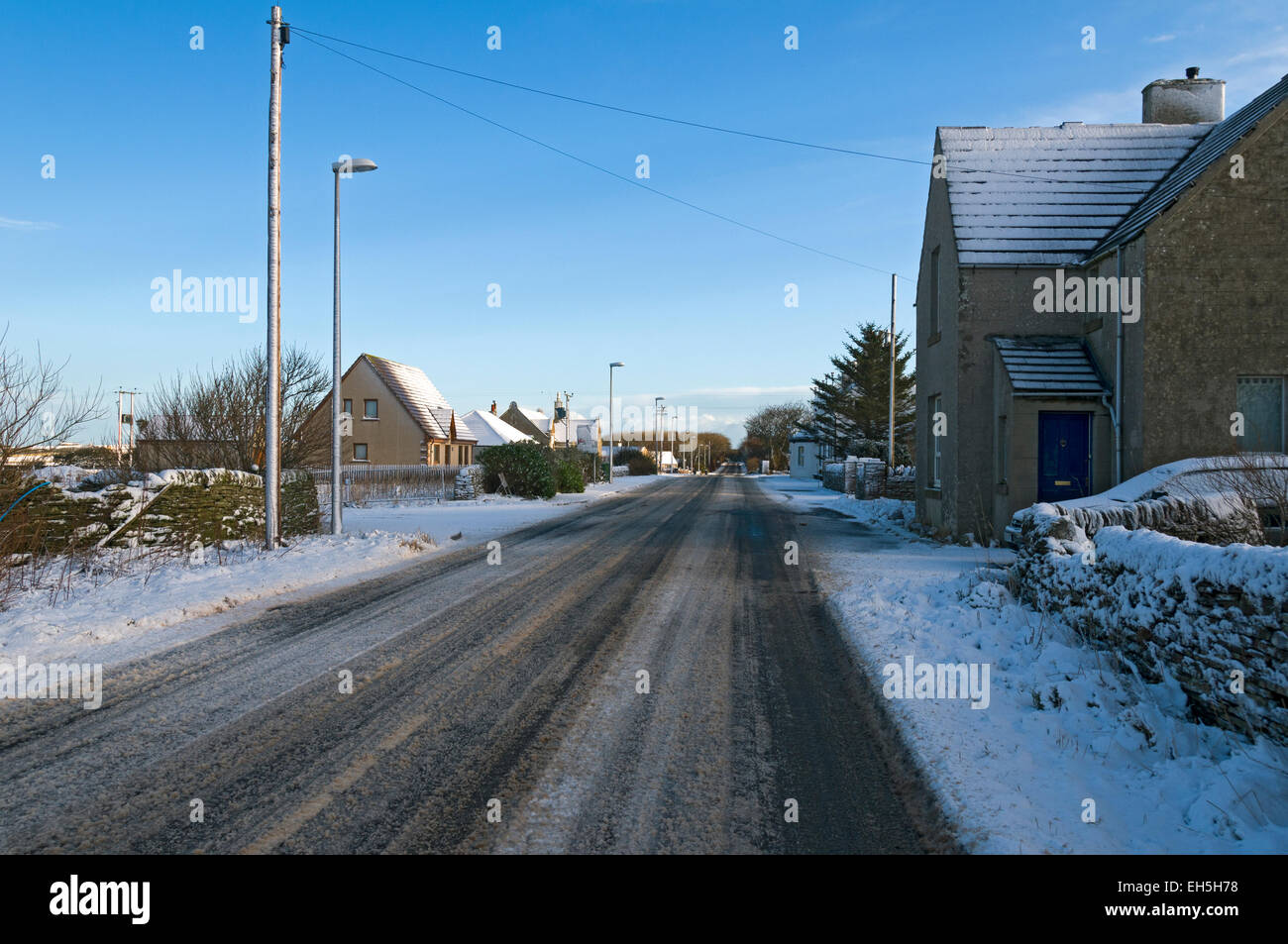 The A836 road after a light snowfall, at the village of Mey, Caithness, Scotland, UK. Stock Photo