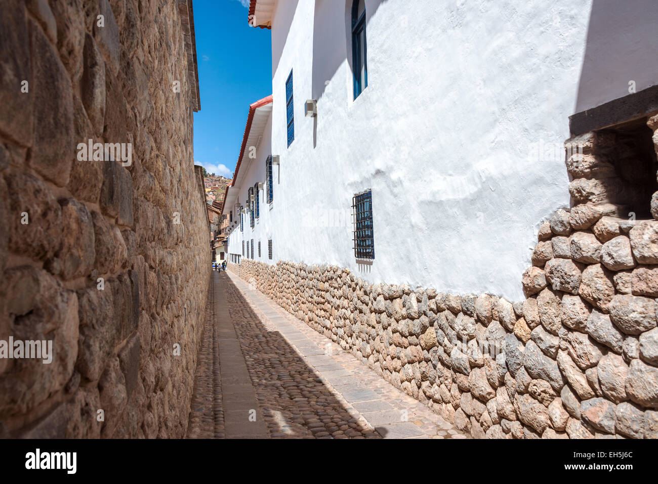 Narrow street alley in Cuzco, Peru with Incan stonework and colonial architecture visible Stock Photo