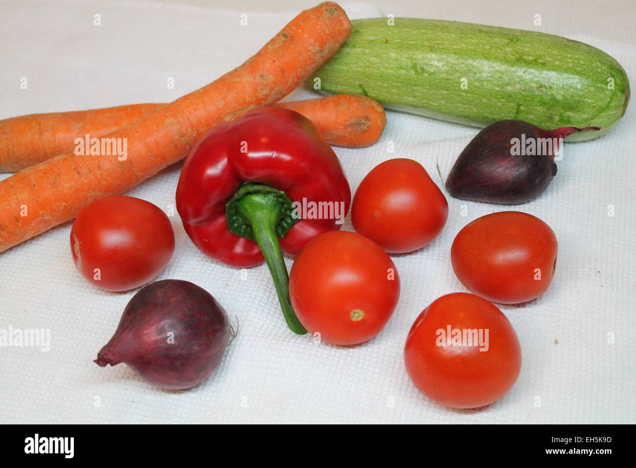 nice colorful full of vitamins and juice vegetables carrot, violet onion, zucchini, tomato, pepper Stock Photo