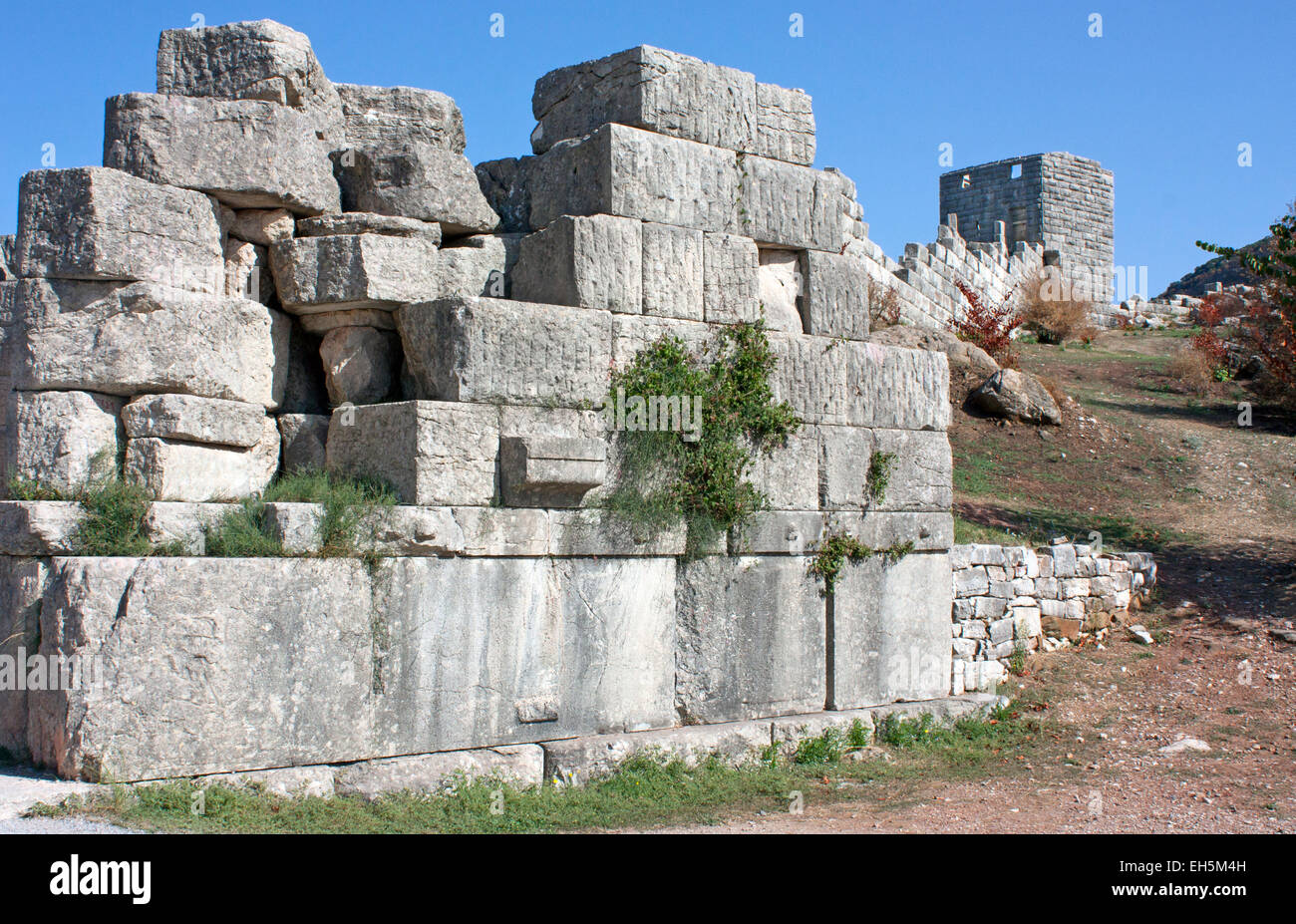 Ruins of the wall of Ancient Messini, with a watchtower in the background, beside the Arcadia Gate. Stock Photo