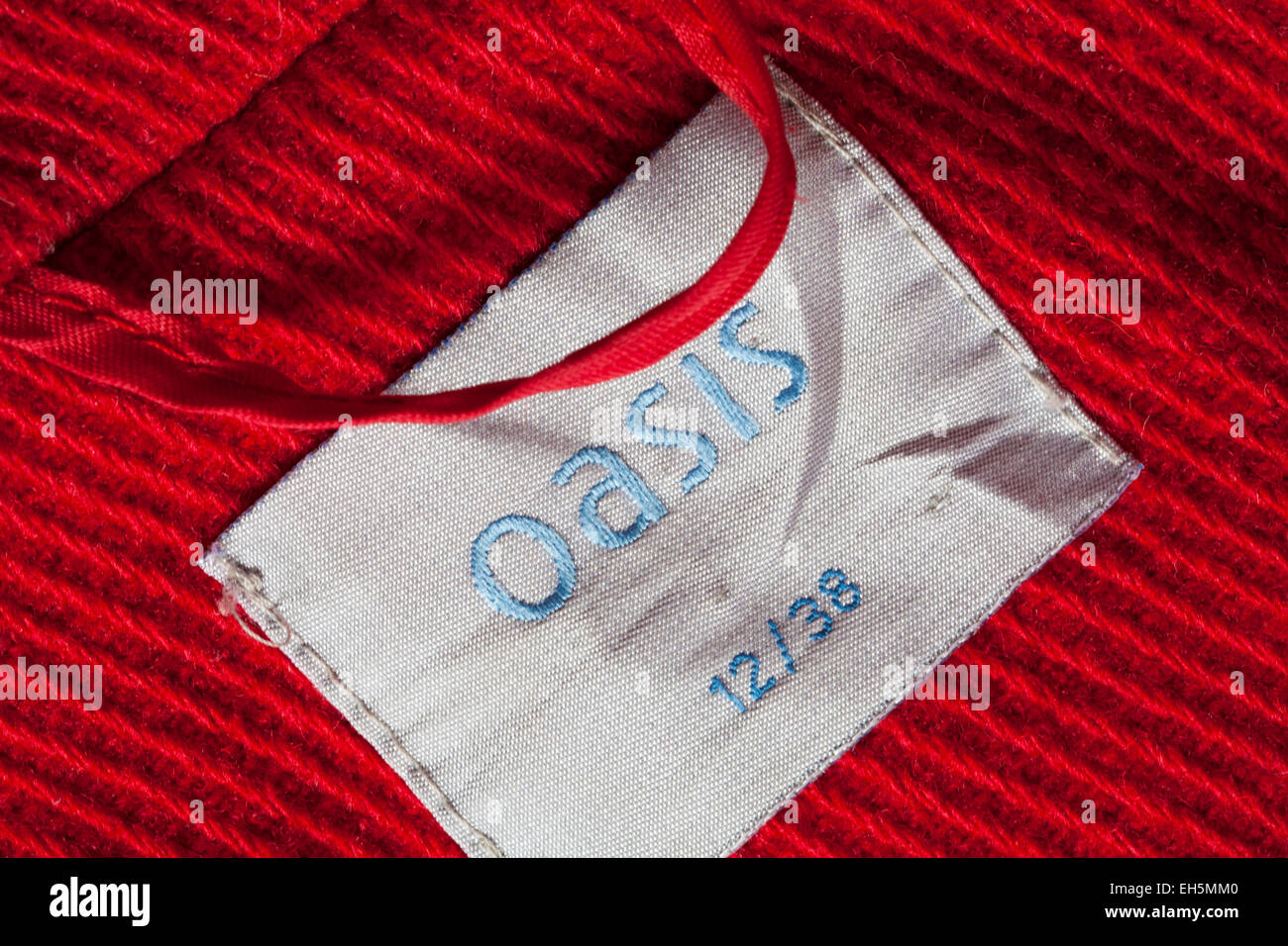 Oasis 12/38 label in red coat clothing Stock Photo - Alamy
