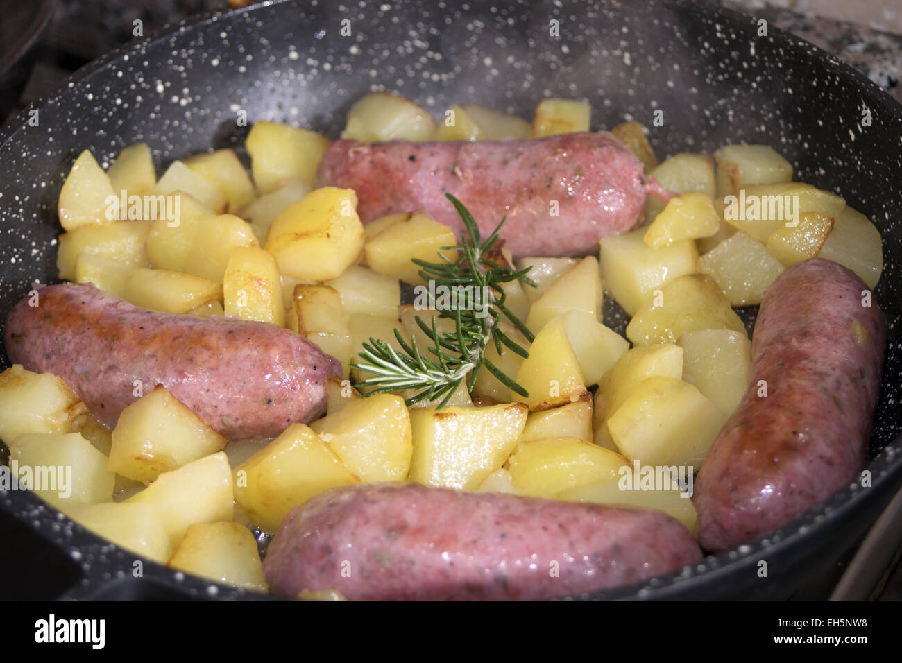 sausages and potatoes in pan Stock Photo