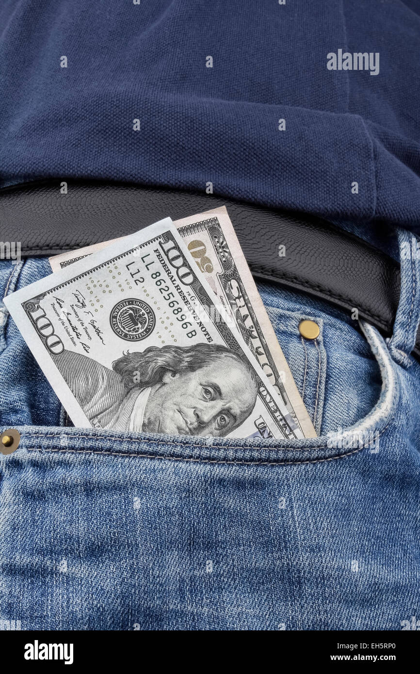 US Dollar (USD) notes in the front pocket of a pair of  blue jeans. (100 and 50 USD note). Stock Photo