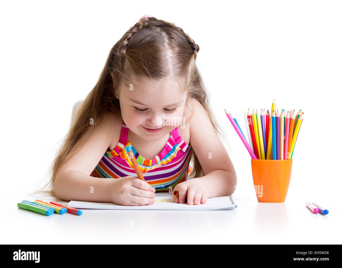 Happy little girl drawing with felt-tip pen in preschool Stock Photo