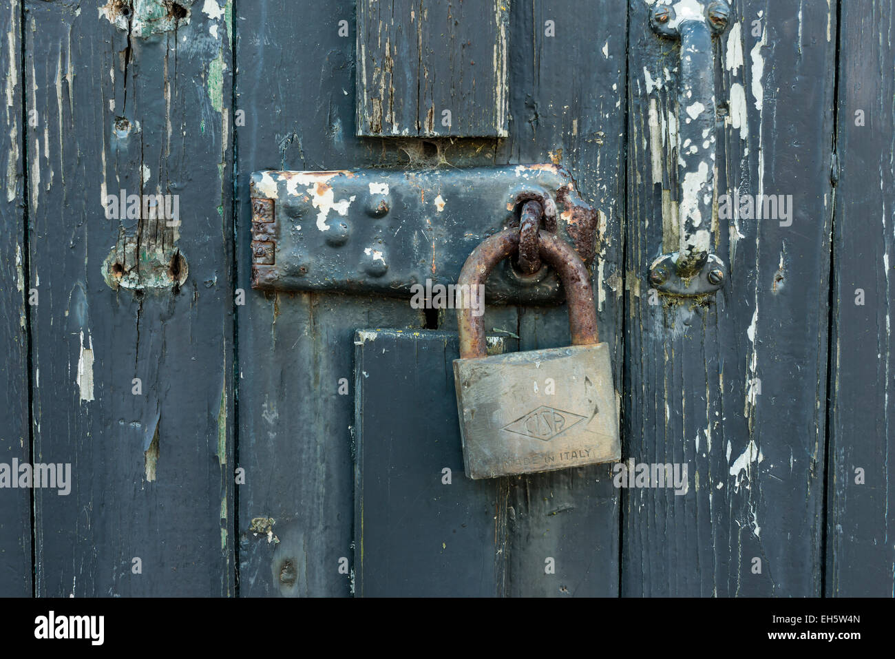 Old wooden green door with rusty padlock Stock Photo - Alamy