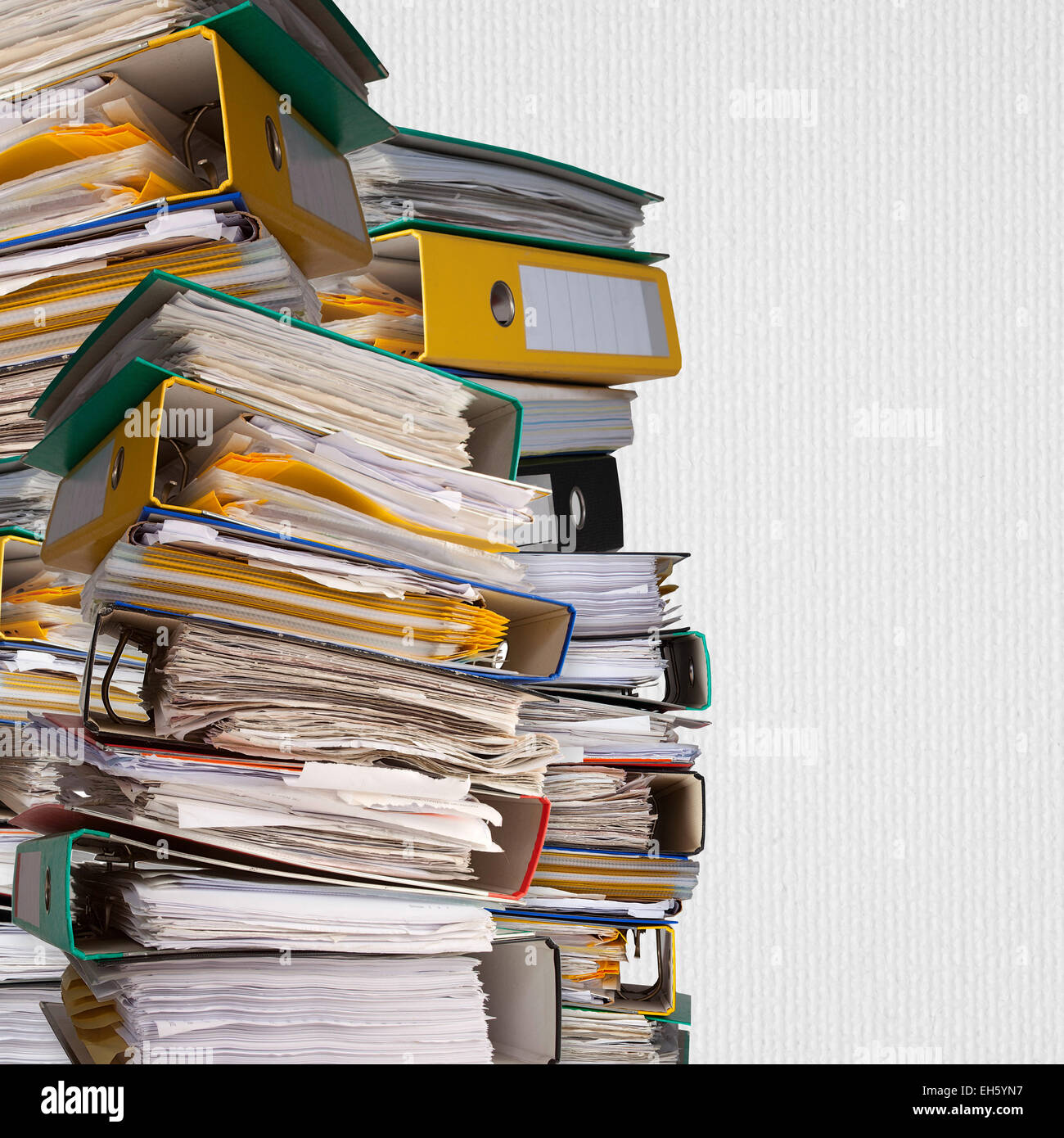 piles of file binder with documents on white paper background Stock Photo
