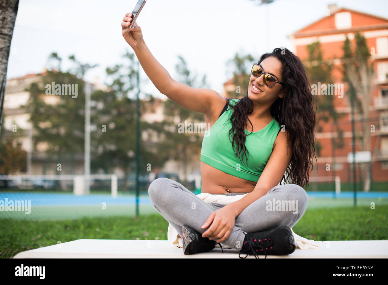 Sporty woman taking selfies at the park Stock Photo