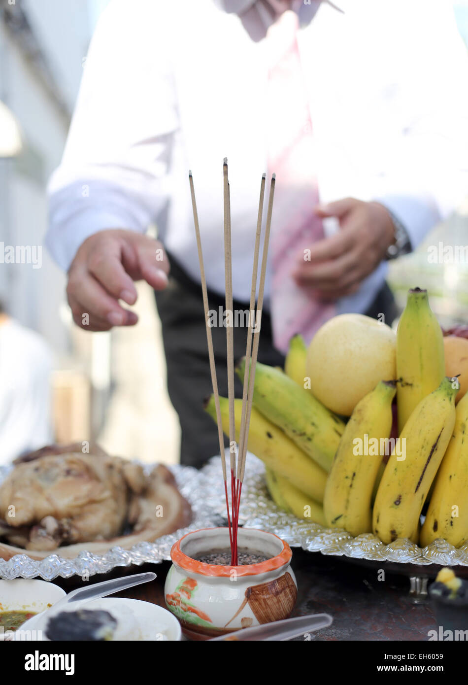 Pay homage with incense and food and beverage. Stock Photo