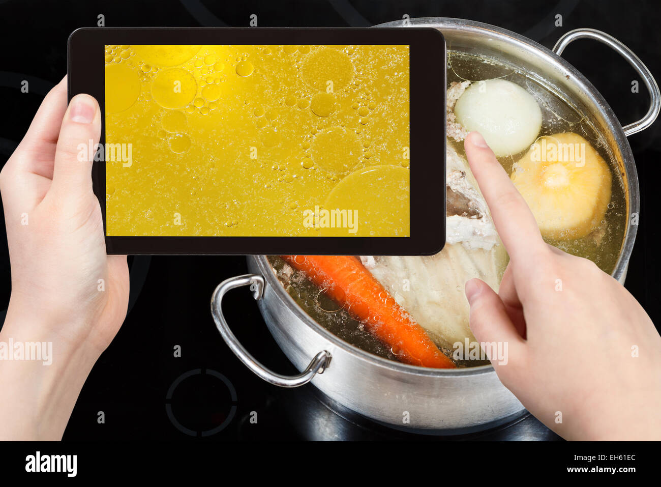 photographing food concept - tourist taking photo of boiling of chicken broth on mobile gadget Stock Photo