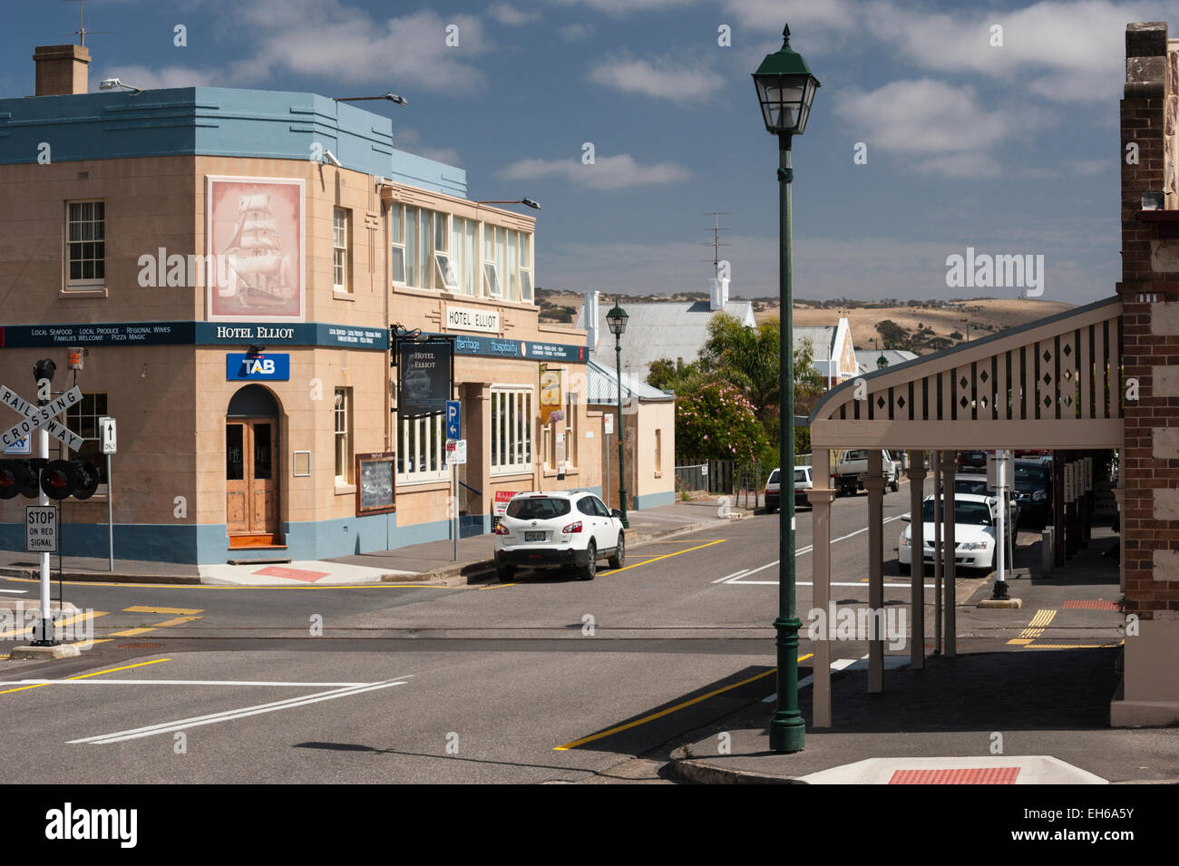 Port Elliot's main street, the Strand, with a focus on the railroad tracks and the pub 'Hotel Elliot' . Stock Photo