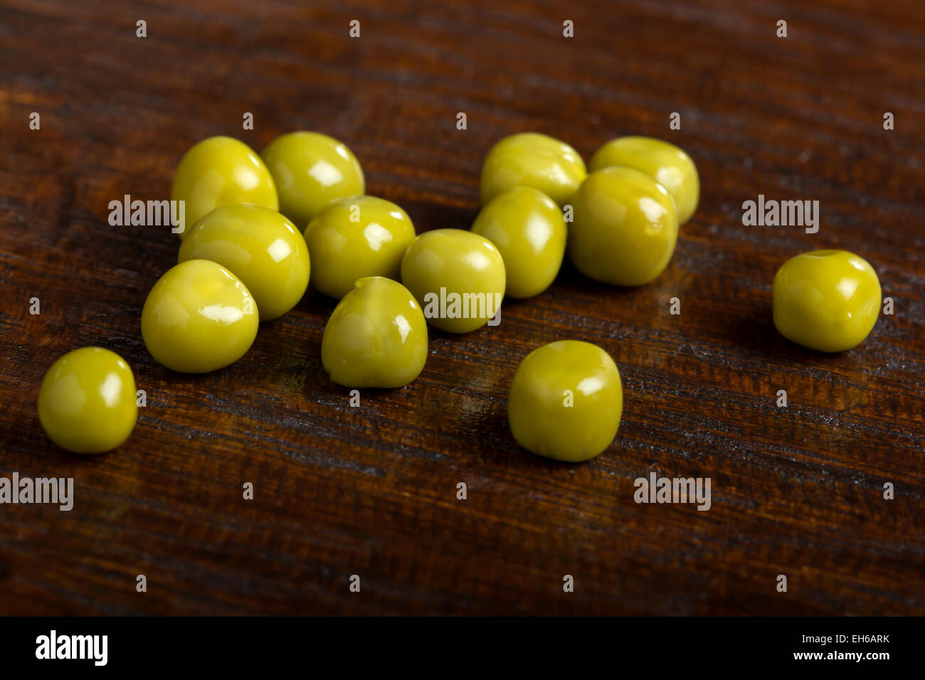Close up of some green peas over wood background Stock Photo