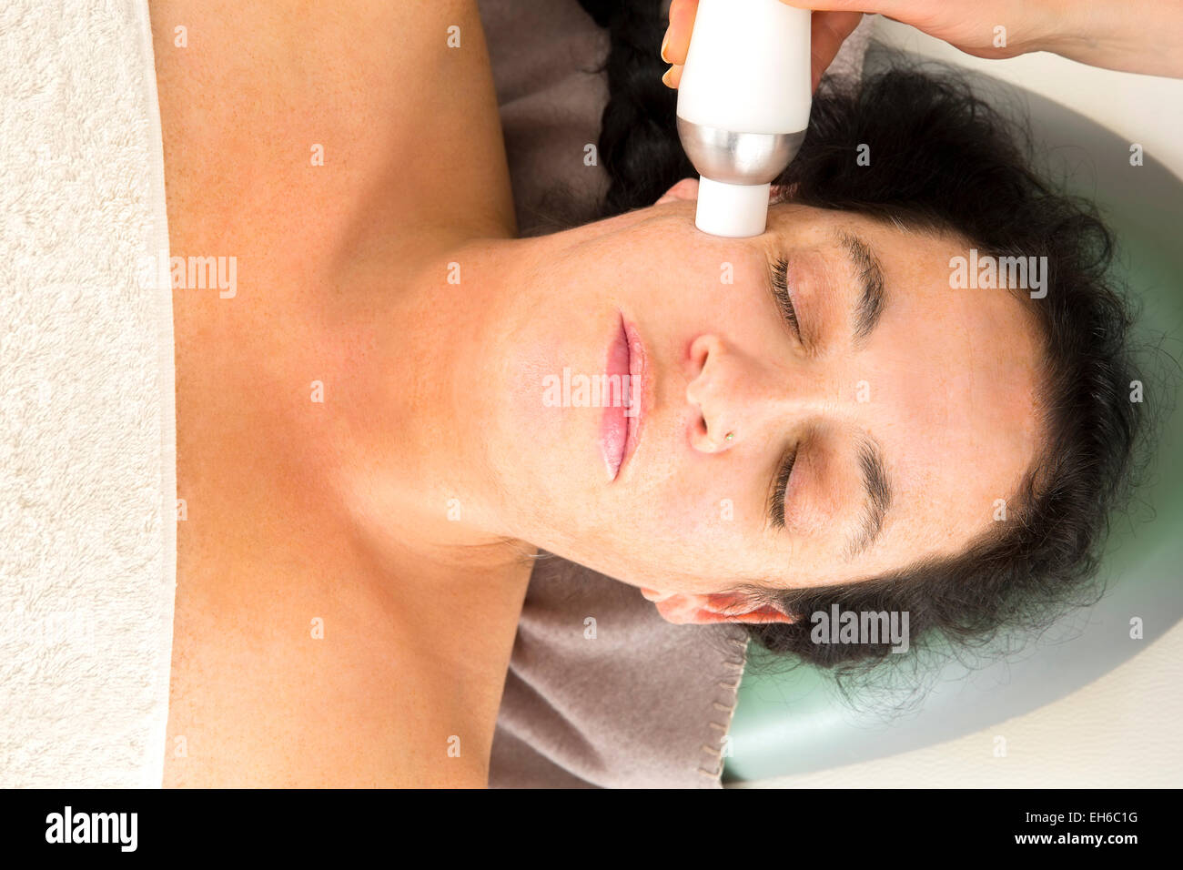 Woman receives diamond peeling at beauty clinic Stock Photo