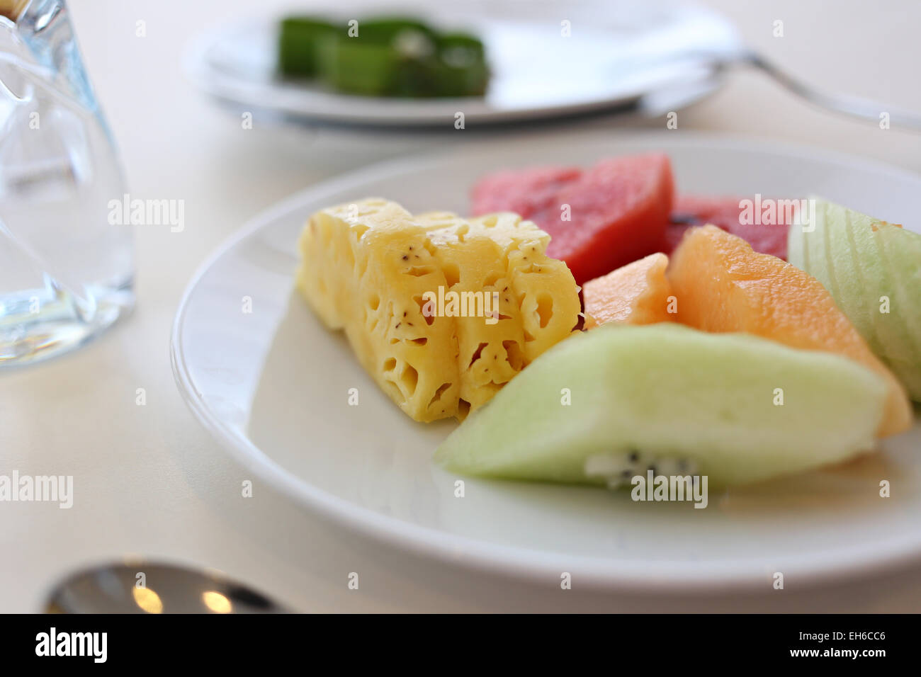 Mixed fruits in white dish on the foods table. Stock Photo