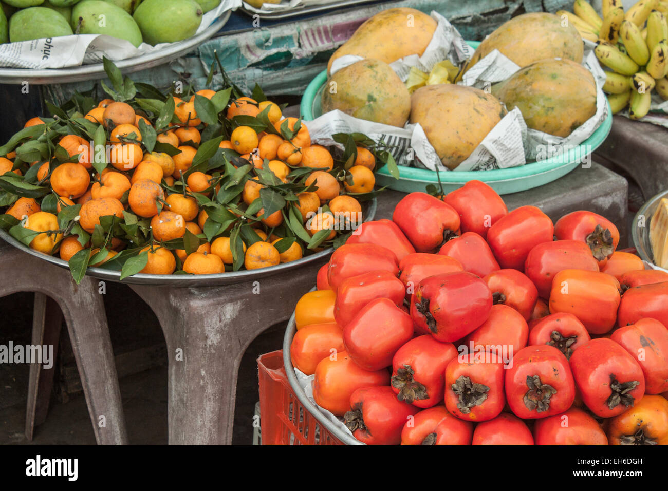 A lot of fresh red persimons, at a market in Phu quoc, Vietnam Stock