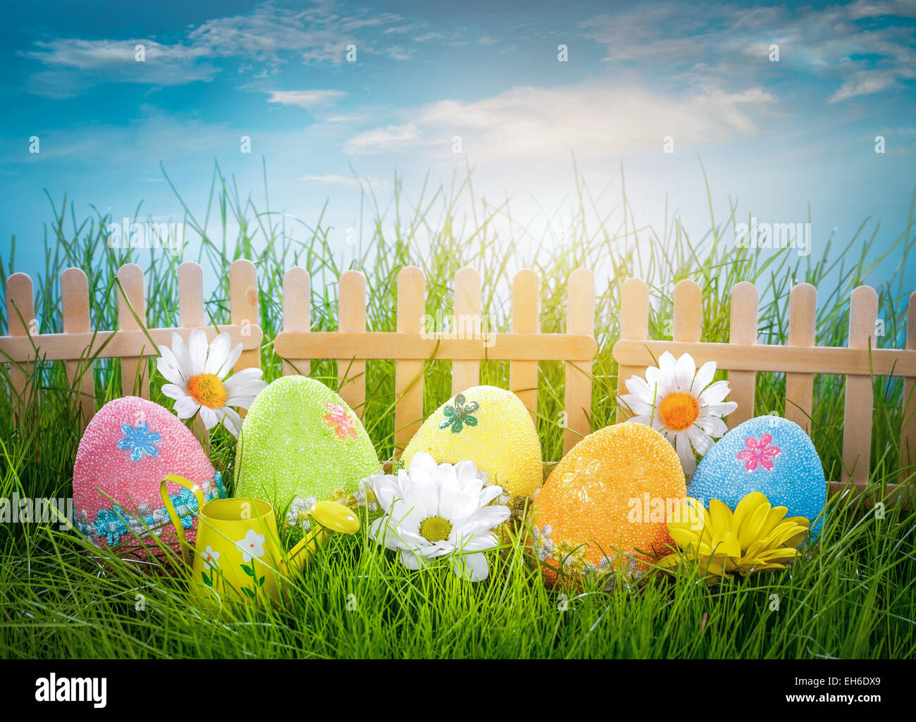 Decorated easter eggs in the grass on blue sky background Stock Photo ...