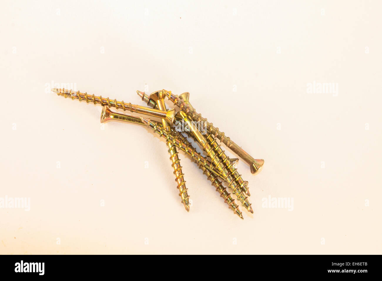 A few golden screws, isolated on white background Stock Photo