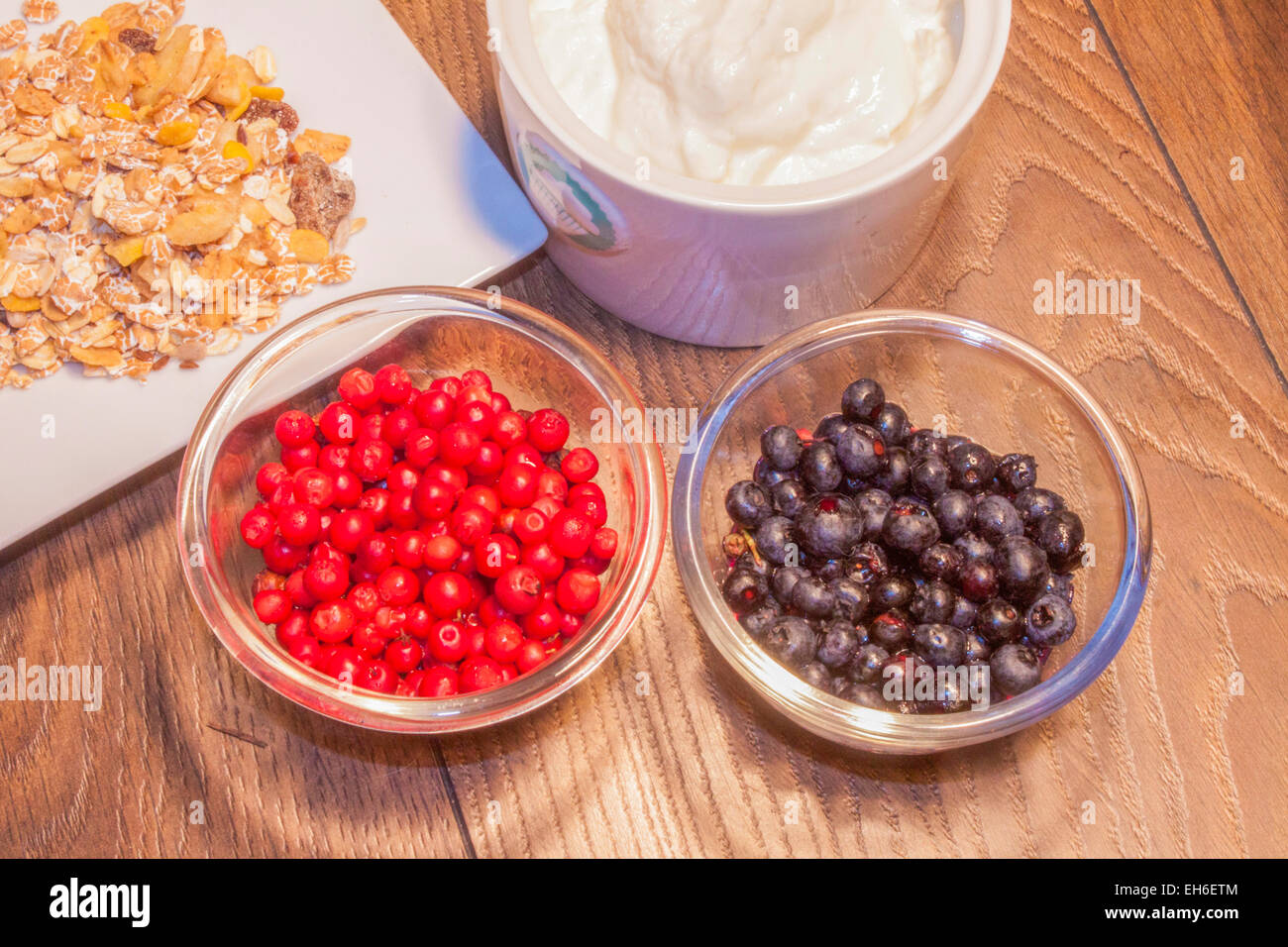 Red lingonberrys and blue blueberrys, on wooden background Stock Photo