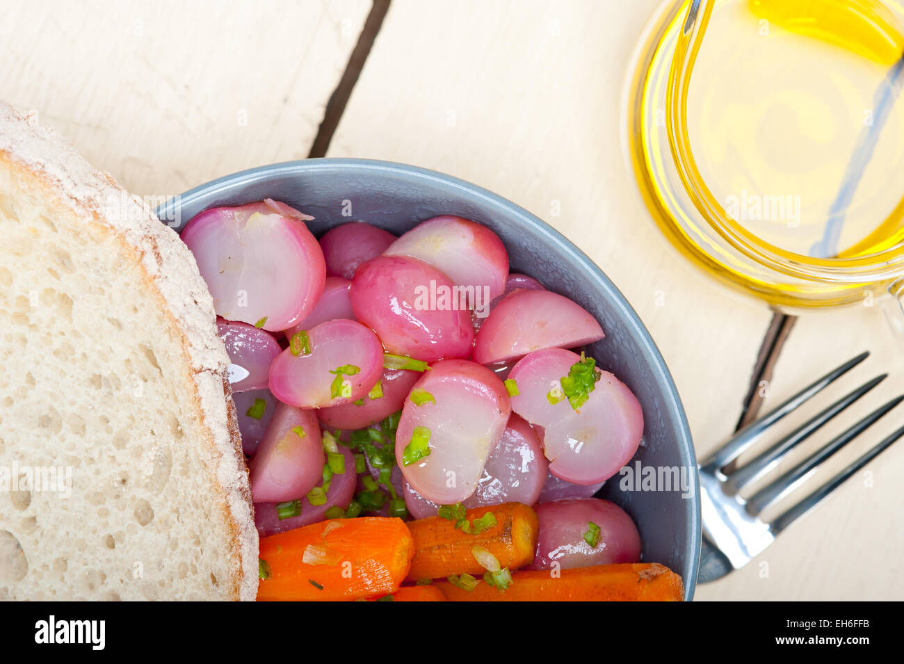 bowl of steamed root vegetable on a rustic white wood table Stock Photo ...