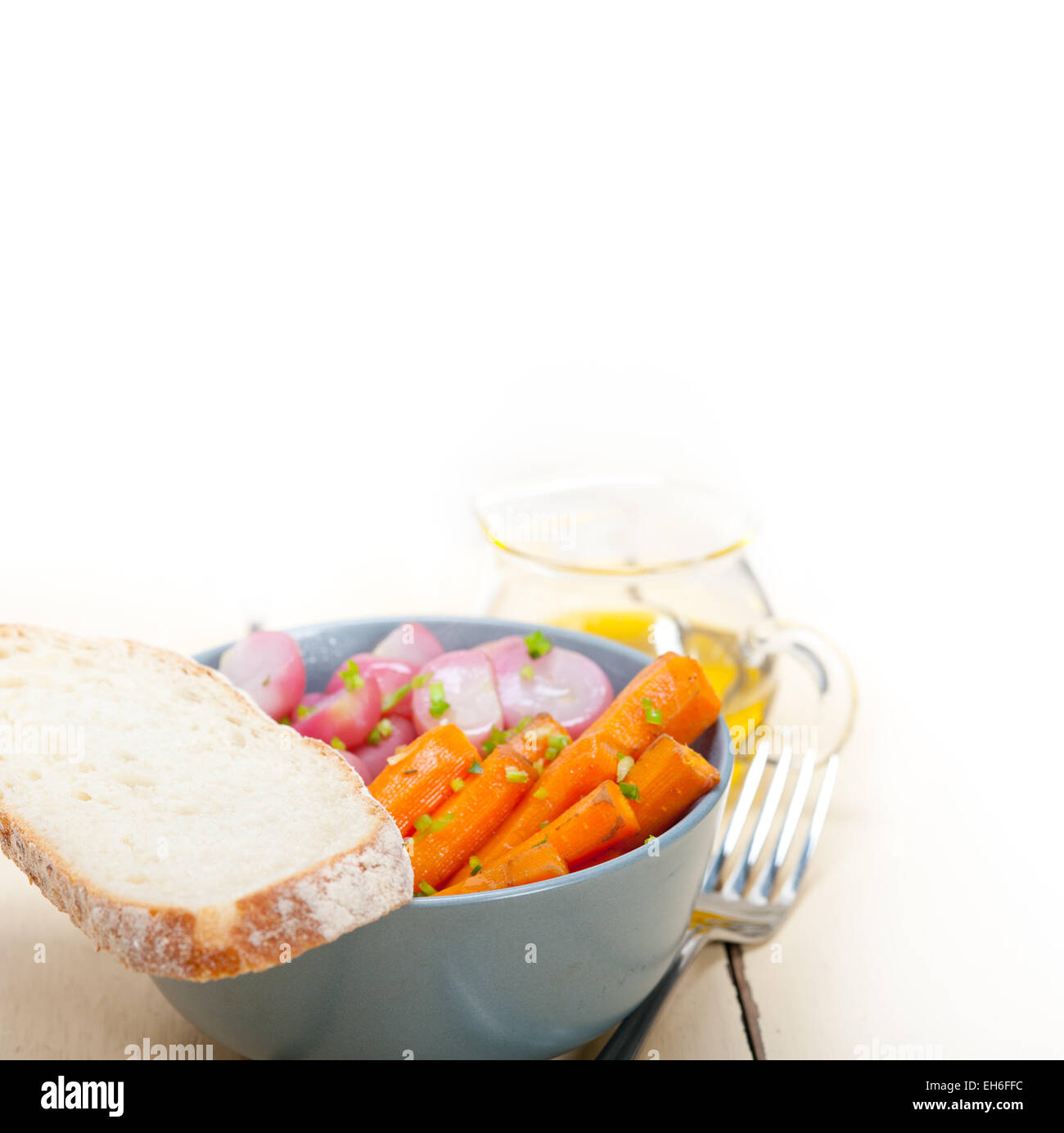 bowl of steamed root vegetable on a rustic white wood table Stock Photo ...
