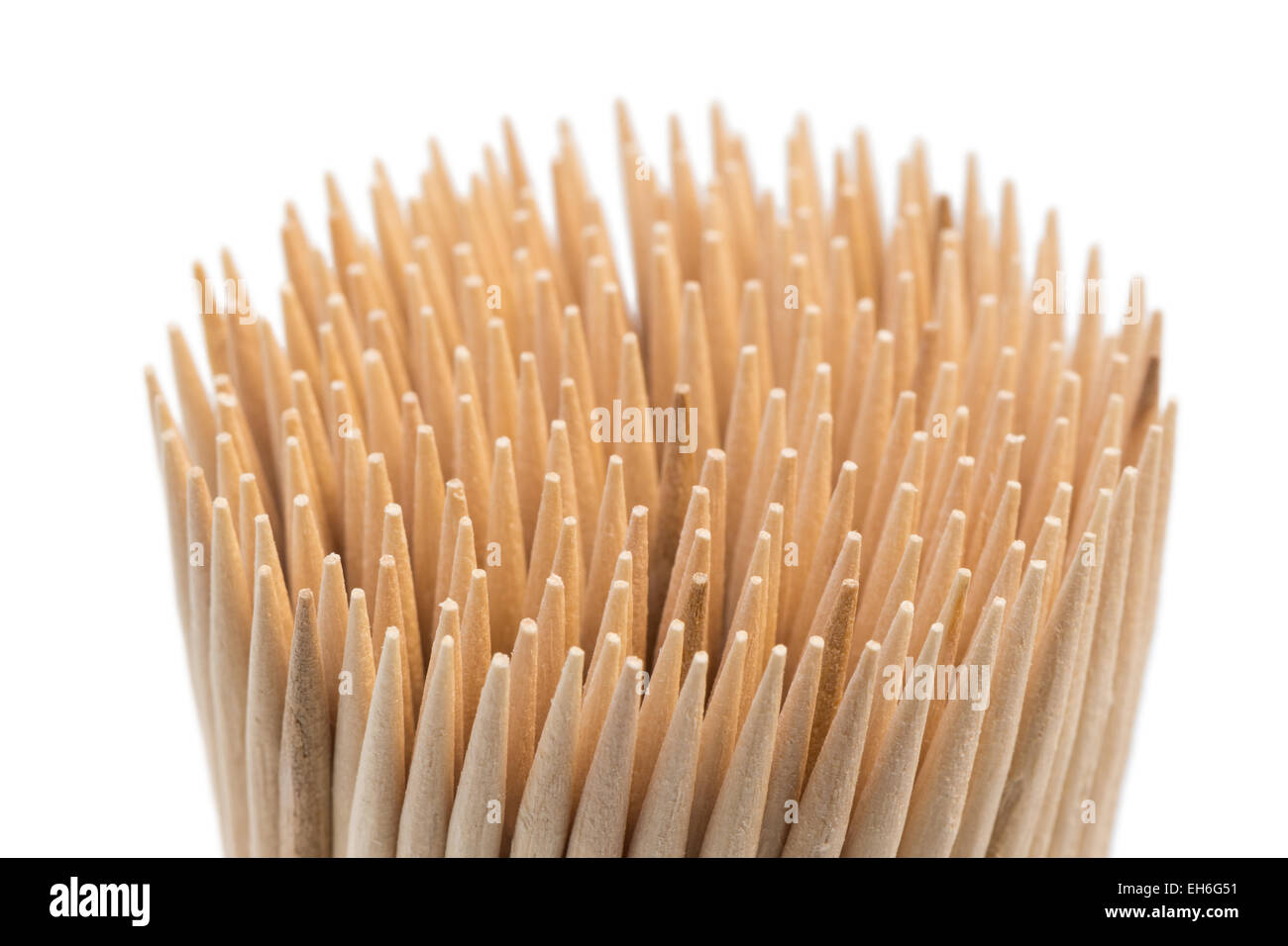 Closeup of stack of wooden toothpicks or cocktail sticks, isolated on