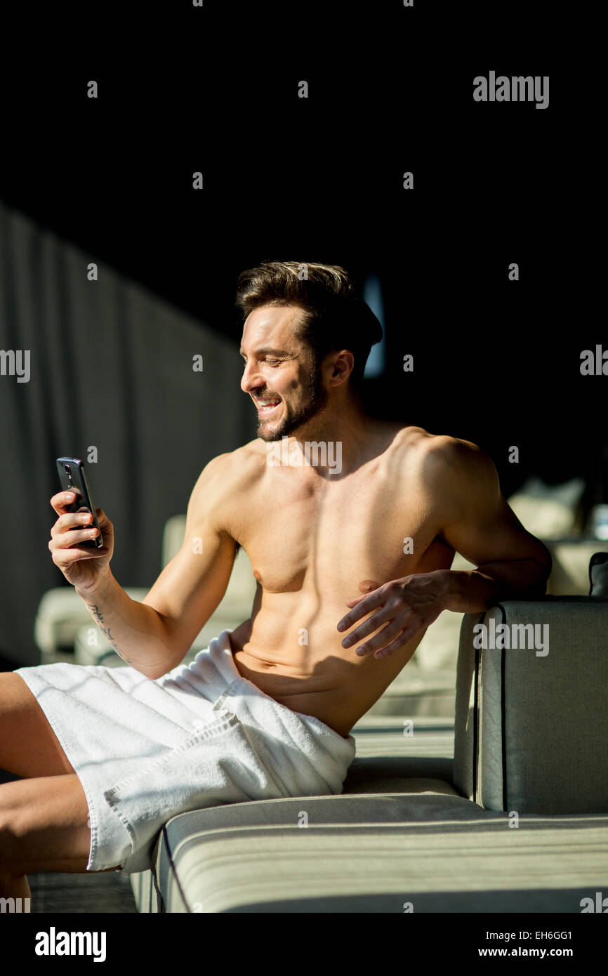 Young man in the room with mobile phone Stock Photo