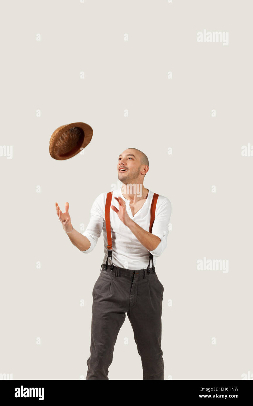 man throws his hat in air, portrait in studio Stock Photo Alamy