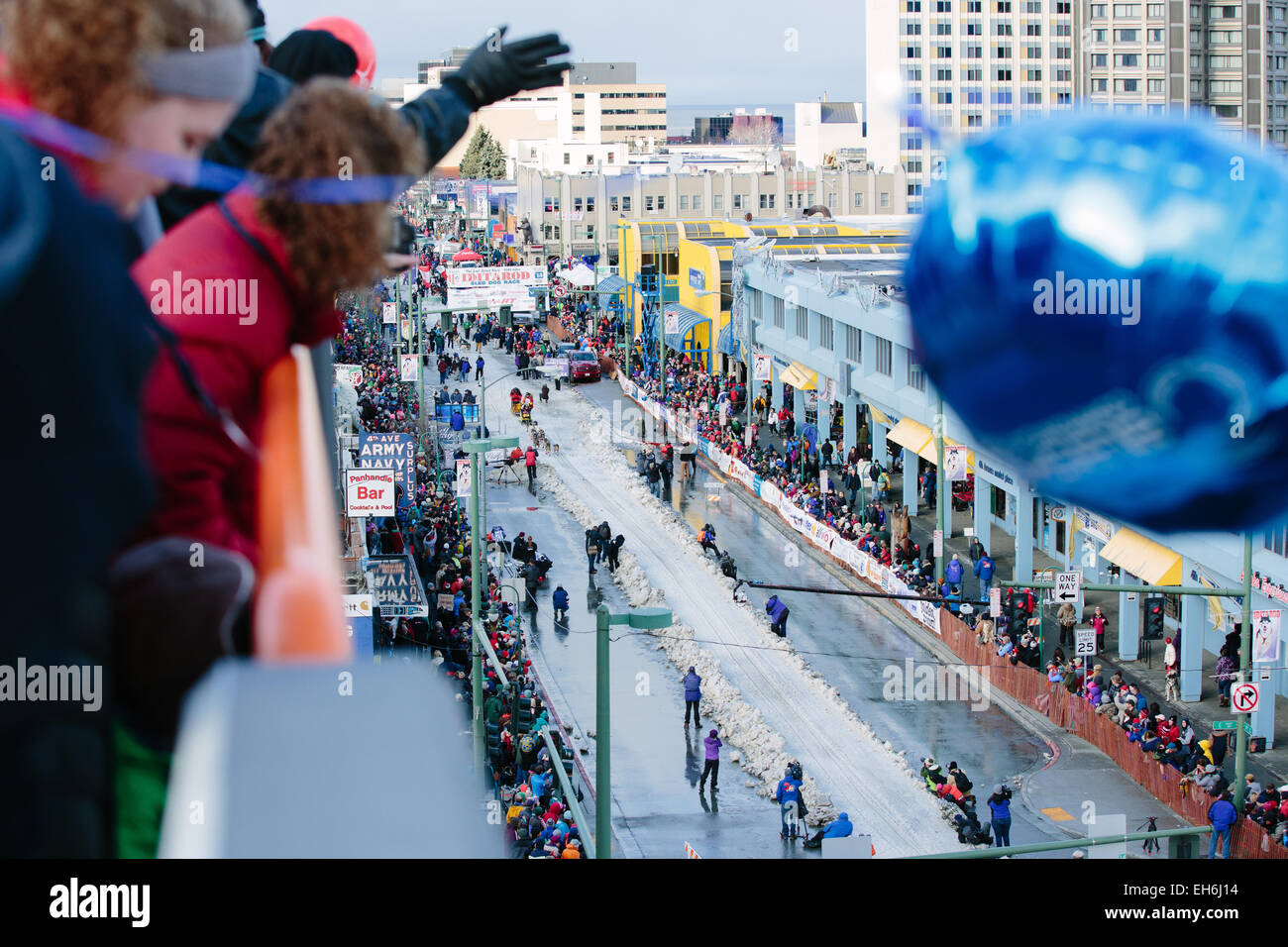 Onlookers cheer as Mitch Seavey of Sterling, Alaska crosses the starting line of the 2015