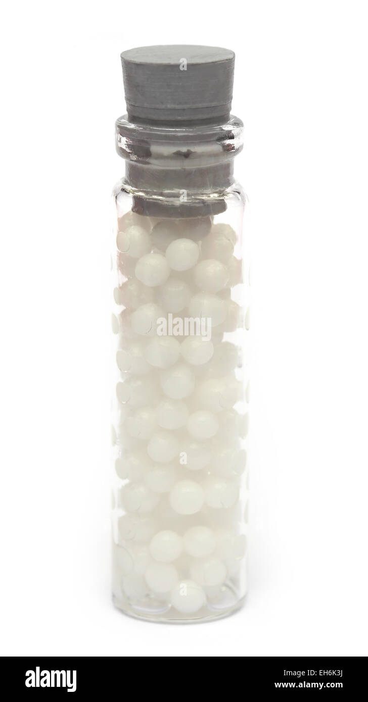 Homeopathic globules in a bottle over white background Stock Photo