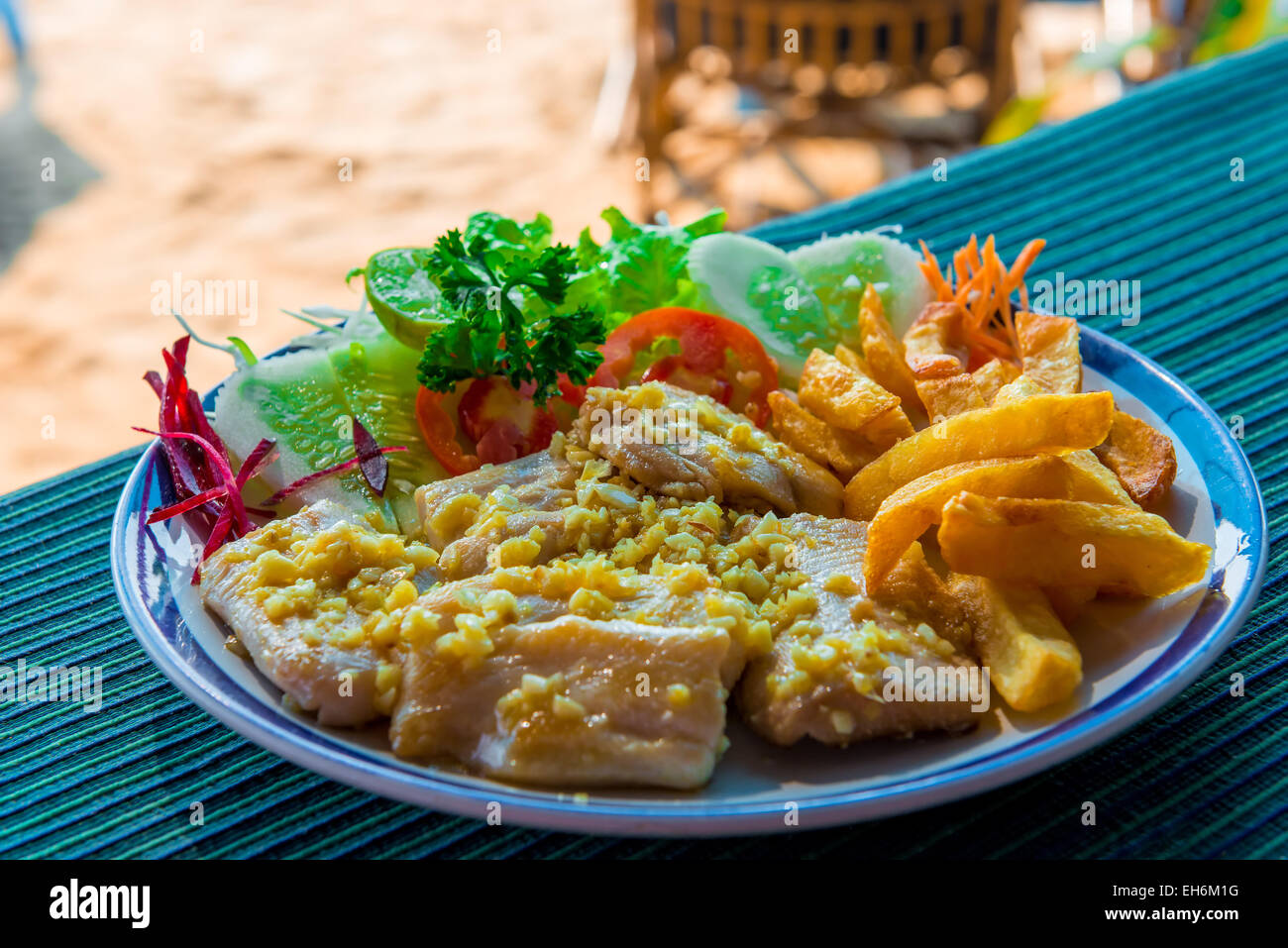 fish fillets with potatoes and salad on a plate Stock Photo