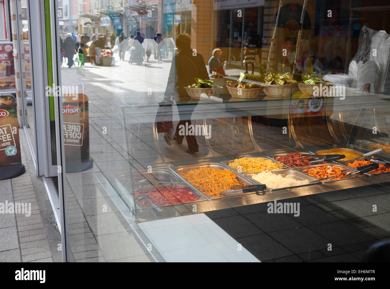 Noodle bar in King's Lynn, Norfolk, with the reflections of pedestrians