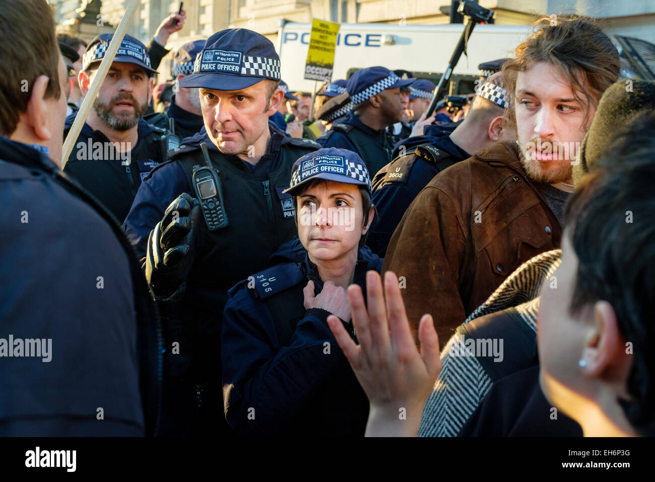 London, UK. 7th March, 2015  'Time for Action' march.  Pictured: Metropolitan police officers confront demonstrators following rally in Westminster. Stock Photo