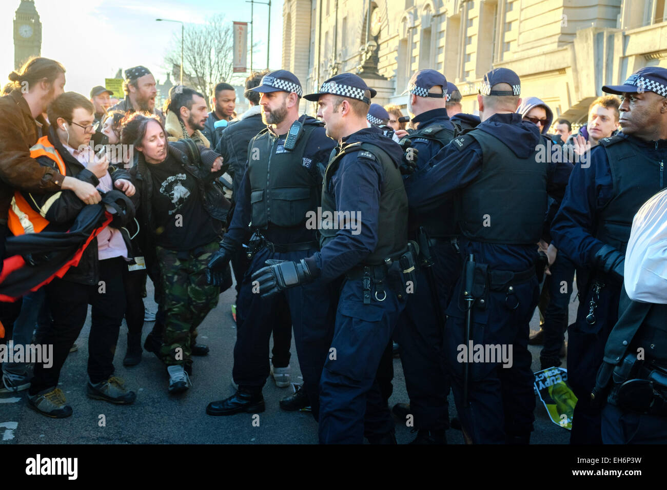 London, UK. 7th March, 2015  'Time for Action' march. . Pictured: Metropolitan police officers confront demonstrators following climate change rally in Westminster. Stock Photo