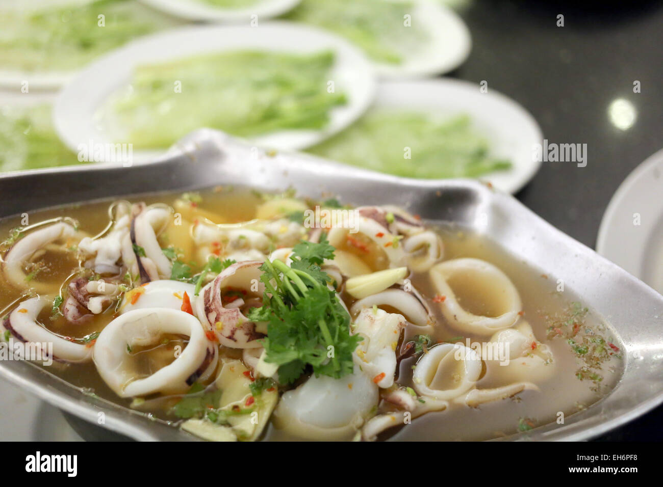 Squid Soup on the prepared casserole served in restaurants. Stock Photo