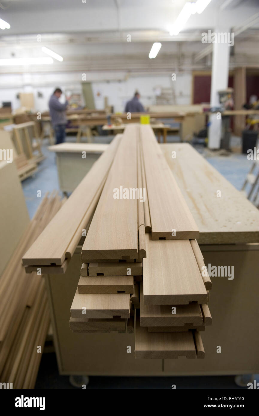 craftsmen work in a woodworking factory preparing high quality