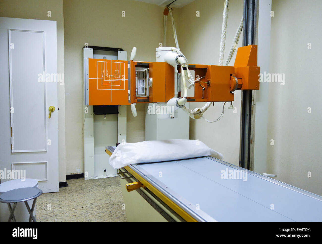 A Radiology room table with X-ray generator in clinic, Spain. Stock Photo