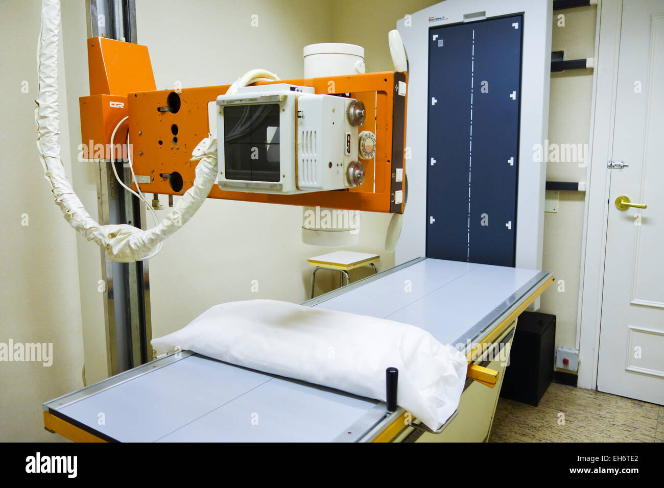 A Radiology room table with X-ray generator in clinic, Spain. Stock Photo