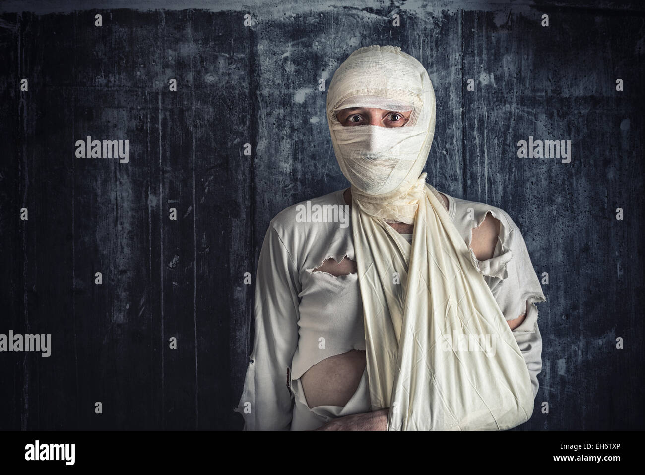 Injured Mad with Brain Concussion and Wounded Head wearing Medical Bandages. Stock Photo