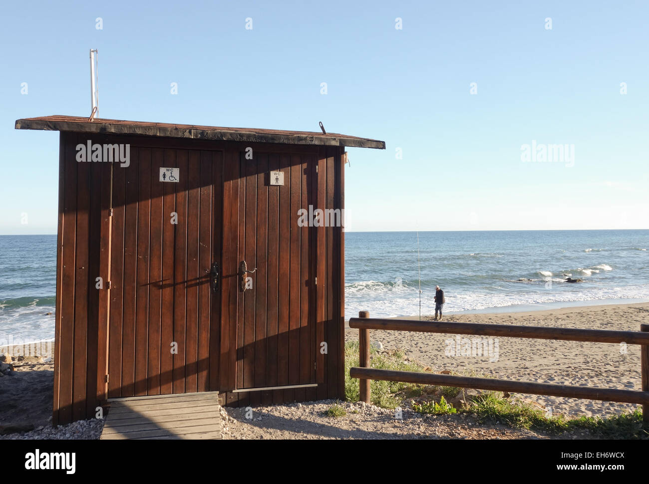 Public toilet, WC, on beach at wooden boardwalk, seafront promenade, Costa del Sol, Andalusia, Spain. Stock Photo