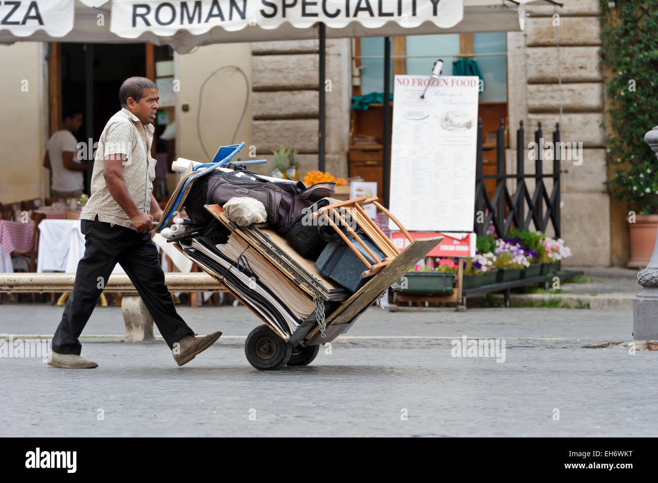 A man pushing a loaded two wheels trolley, Rome, Italy Stock Photo - Alamy