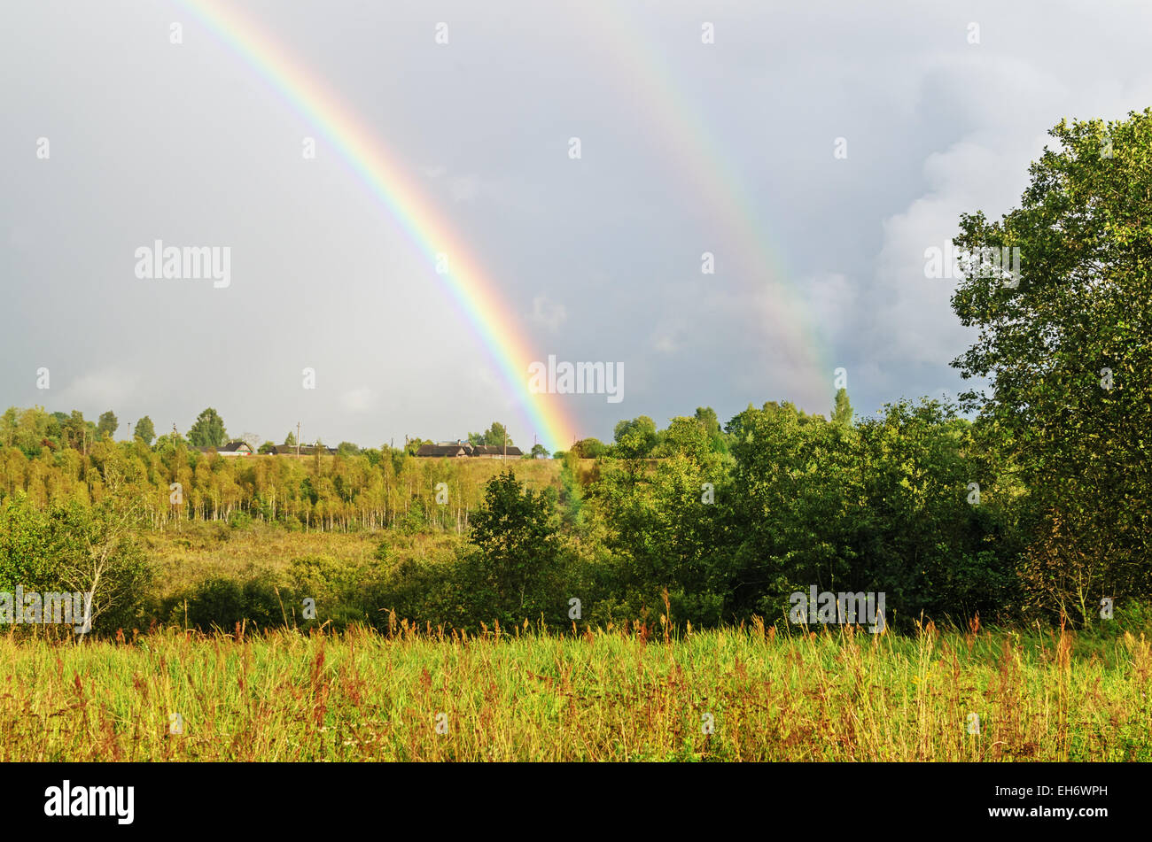 Village rainbow landscape Stock Photo - Alamy