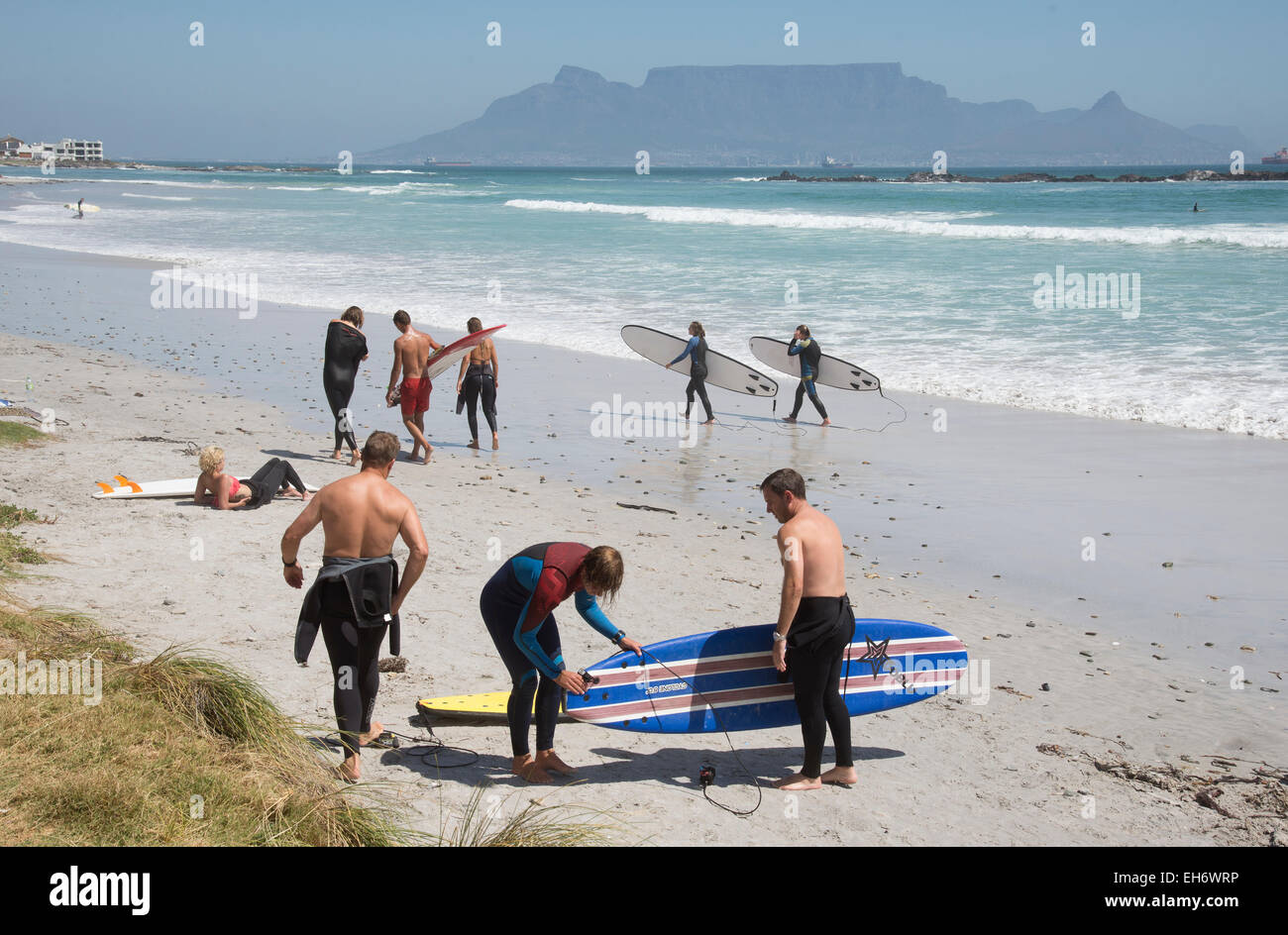 Surf boarders on the beach at Bloubergstrand a resort near Cape Town South Africa Stock Photo