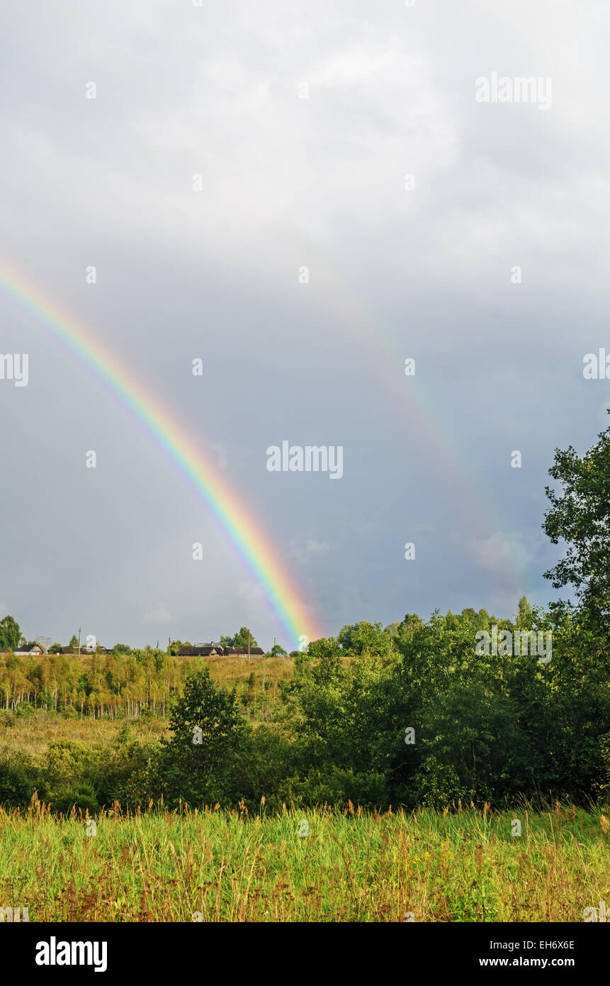 Village rainbow landscape Stock Photo - Alamy