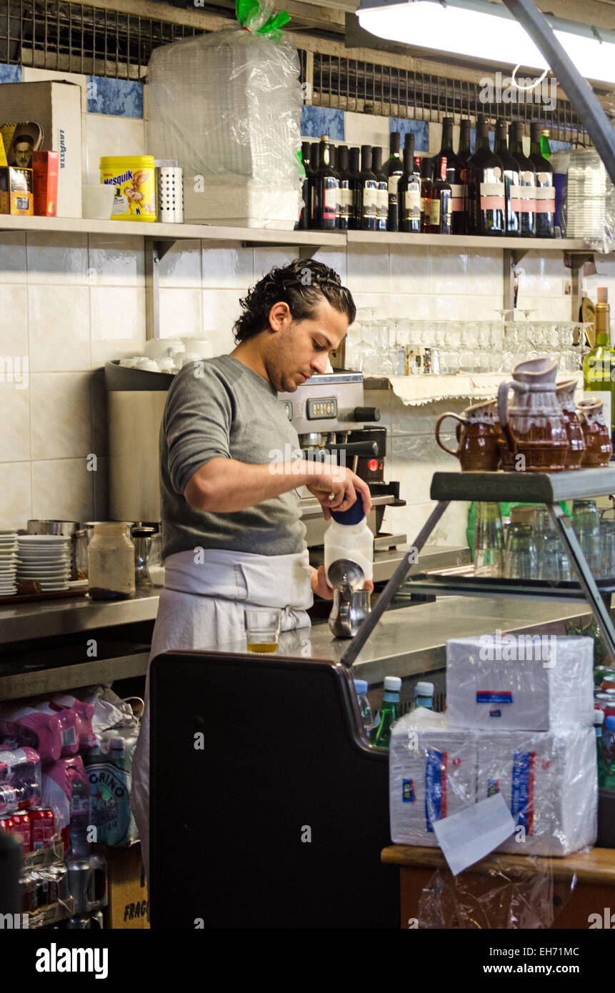 A man prepares coffee at a restaurant in Le Marché des Enfants Rouges, an organic marketplace in Paris. Stock Photo