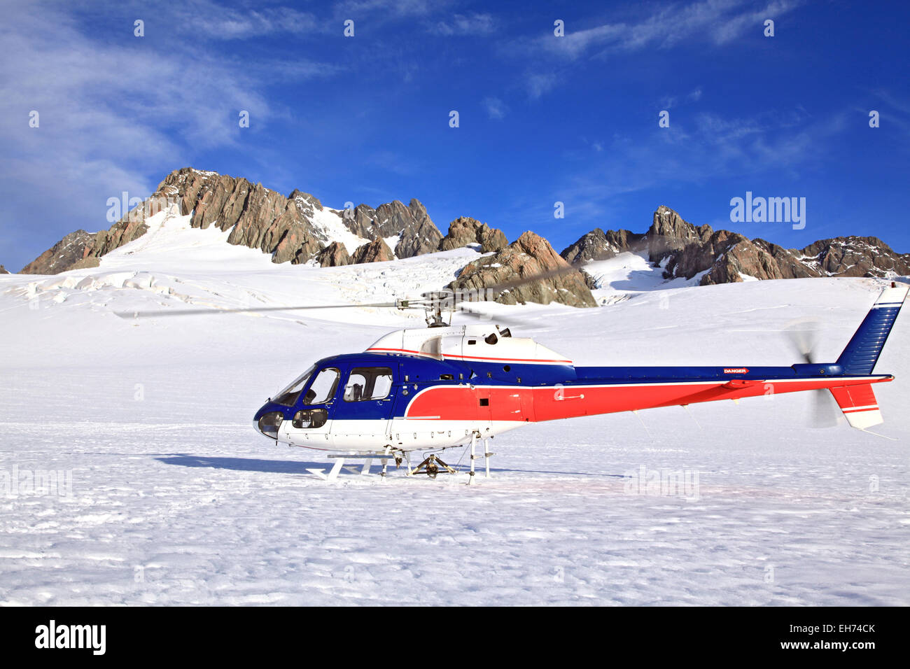 Helicopter landing on top of Franz Josef Glacier in New Zealand. Stock Photo