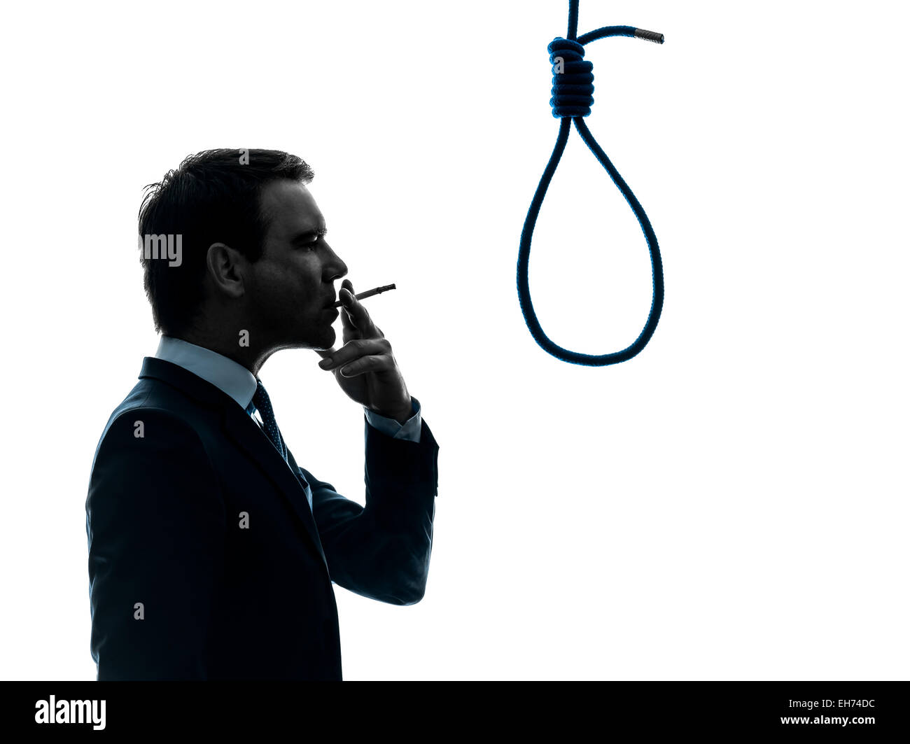 one  man smoking cigarette standing in front of hangman's noose in silhouette studio isolated on white background Stock Photo