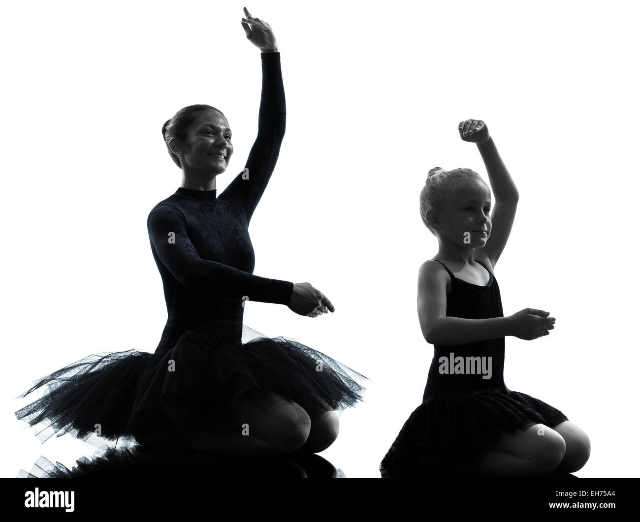 woman and little girl ballerina ballet dancer dancing in silhouette on